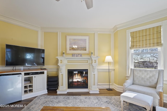 interior space featuring ceiling fan, dark wood-type flooring, and crown molding