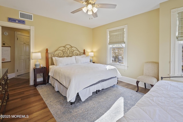 bedroom with ceiling fan and dark hardwood / wood-style flooring