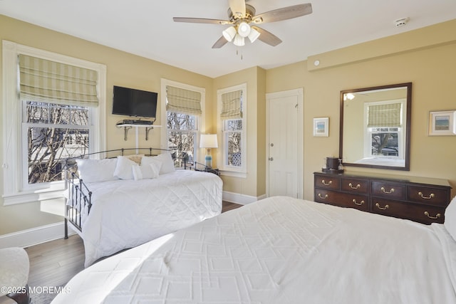 bedroom with ceiling fan and hardwood / wood-style flooring