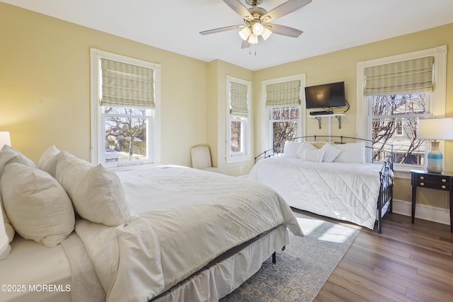 bedroom featuring ceiling fan and dark hardwood / wood-style floors