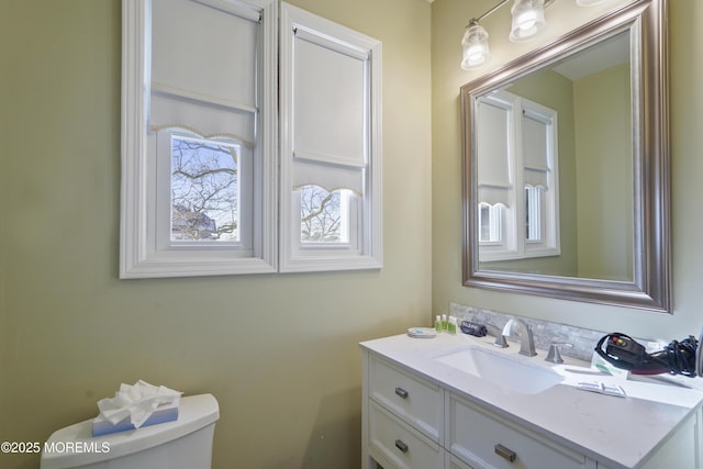 bathroom featuring toilet and vanity