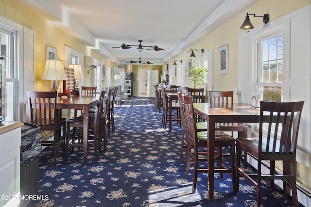 dining room featuring carpet, ceiling fan, and a wall mounted air conditioner