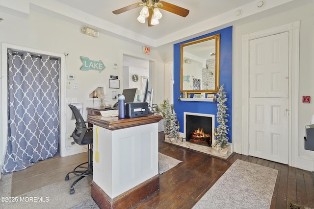 office area with ceiling fan and dark hardwood / wood-style flooring