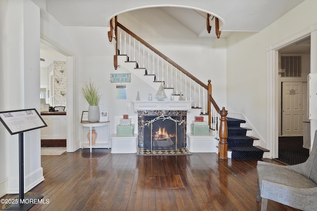 living room featuring dark hardwood / wood-style floors and a high end fireplace