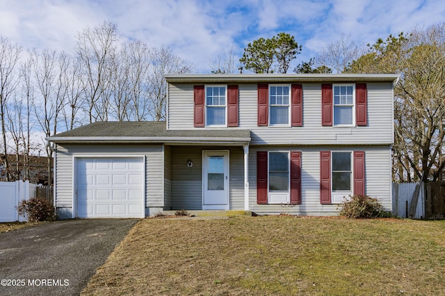 front facade featuring a front yard and a garage