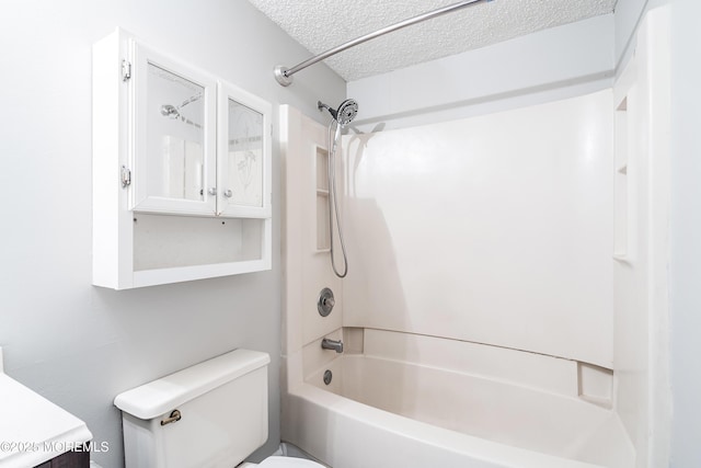 full bathroom featuring a textured ceiling, toilet, shower / bath combination, and vanity