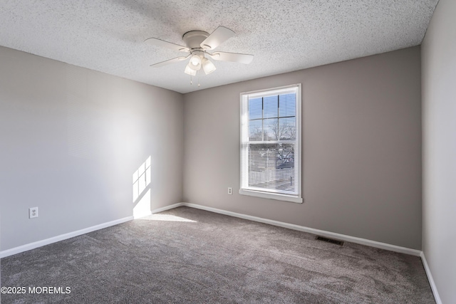 carpeted spare room with ceiling fan and a textured ceiling