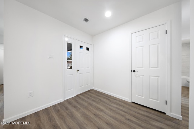 spare room with dark wood-type flooring