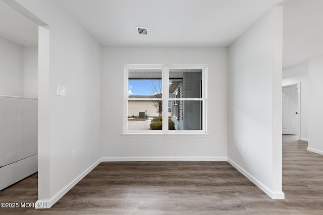 spare room featuring dark hardwood / wood-style floors