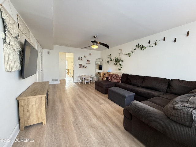 living room featuring ceiling fan and light hardwood / wood-style floors