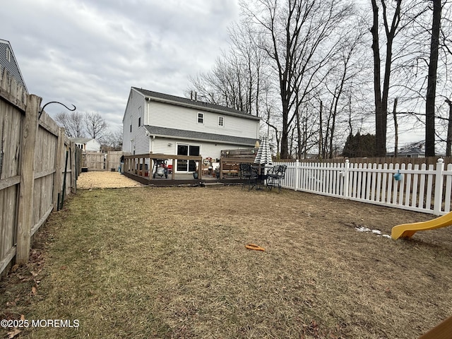 view of yard with a wooden deck and a jacuzzi