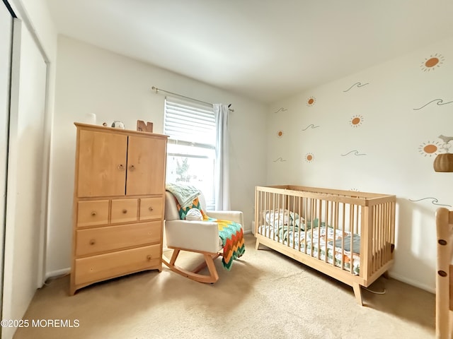 bedroom with a crib and carpet flooring