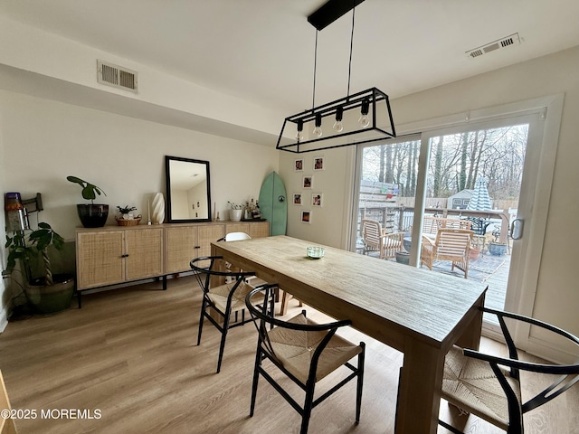 dining space with hardwood / wood-style flooring