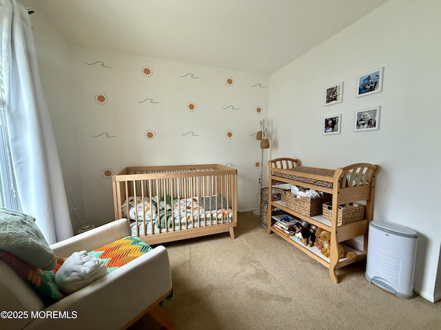 bedroom featuring carpet floors and a nursery area