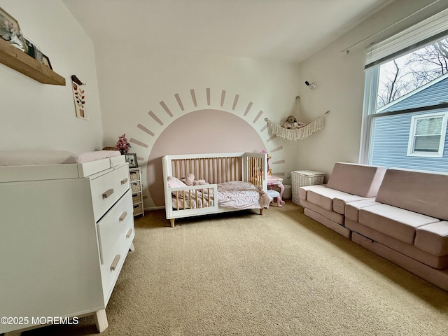 carpeted bedroom with a crib