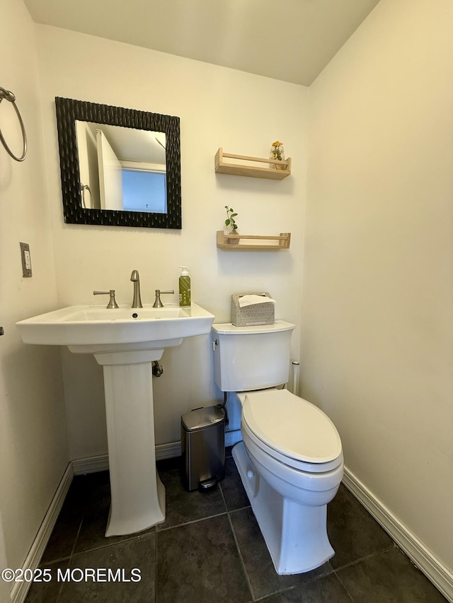 bathroom with tile patterned floors and toilet