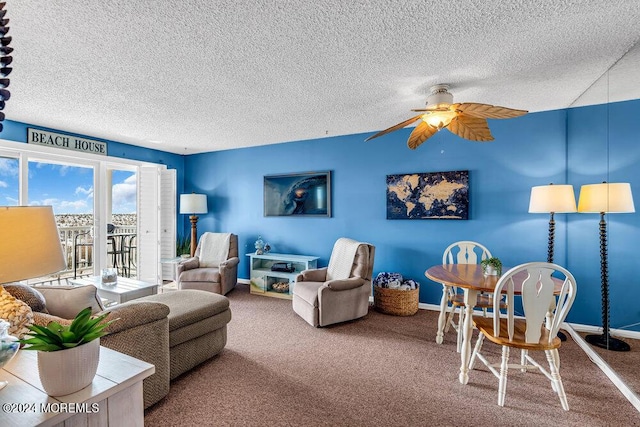 living room with a textured ceiling, carpet floors, and ceiling fan