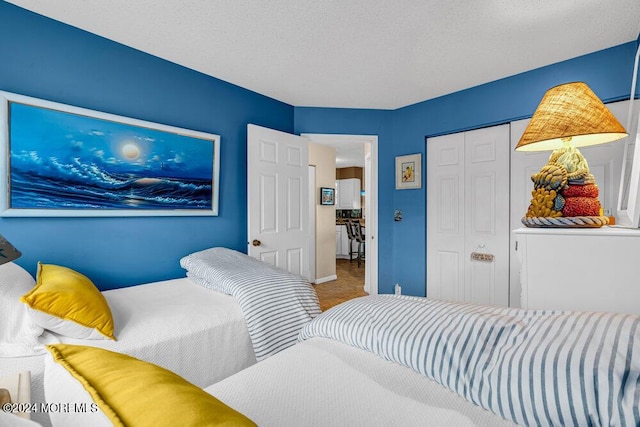 bedroom featuring a closet, carpet flooring, and a textured ceiling