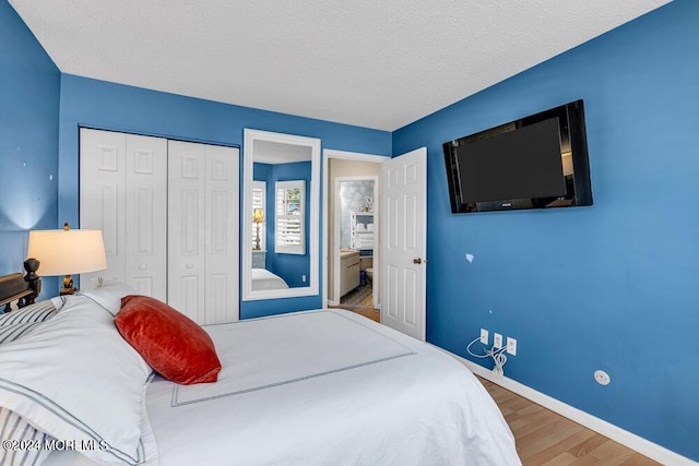 bedroom featuring a textured ceiling, a closet, and hardwood / wood-style flooring