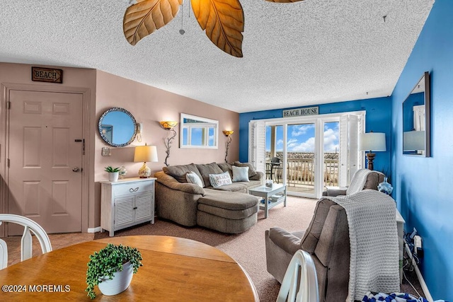 living room featuring a textured ceiling and carpet