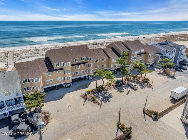 drone / aerial view featuring a water view and a view of the beach