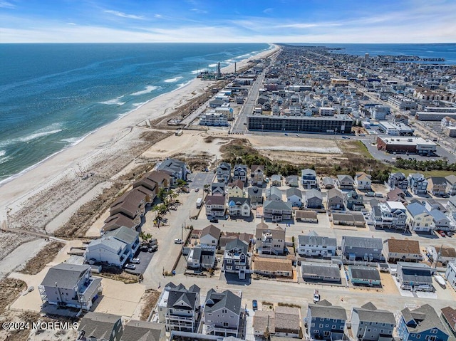 birds eye view of property with a beach view and a water view