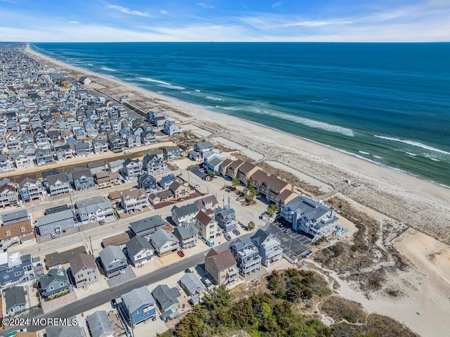 drone / aerial view with a beach view and a water view