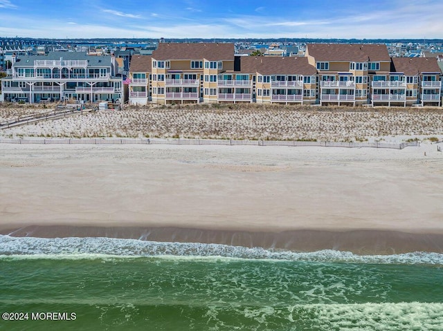 drone / aerial view with a beach view and a water view