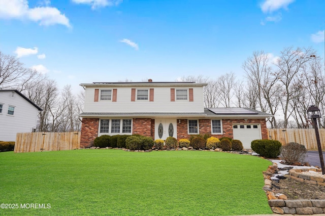 view of front property with a front yard and a garage