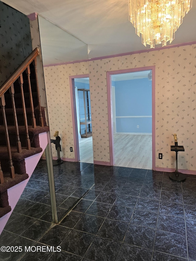 unfurnished room with a notable chandelier