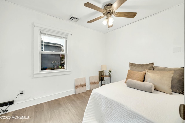 bedroom with ceiling fan and light hardwood / wood-style floors