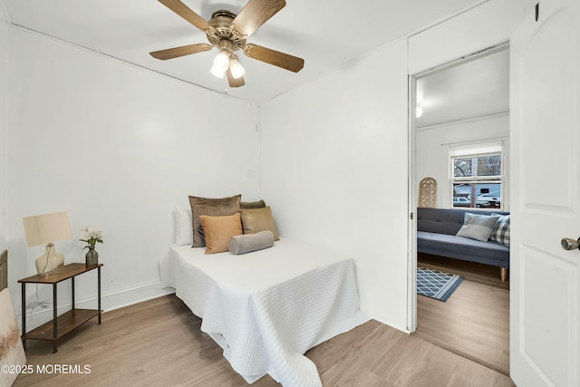 bedroom with ceiling fan and wood-type flooring