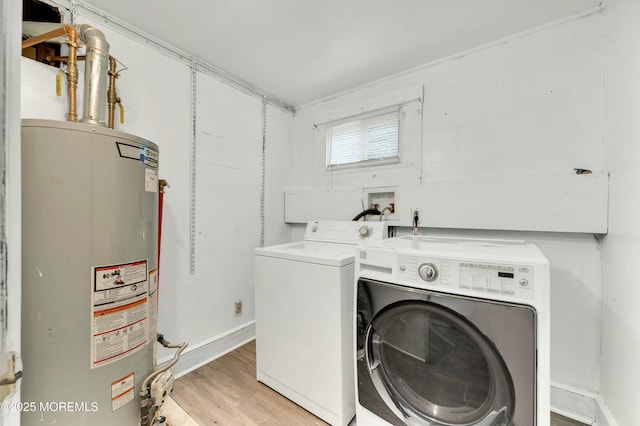 laundry room with gas water heater, separate washer and dryer, and light hardwood / wood-style flooring