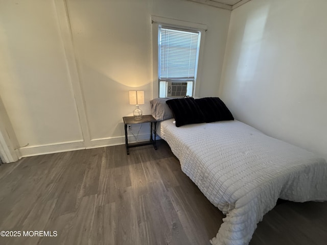 bedroom with cooling unit and dark wood-type flooring