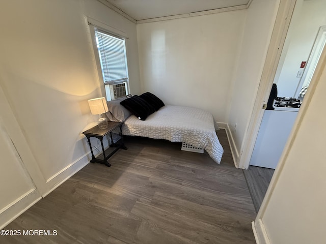 bedroom featuring cooling unit, crown molding, and dark hardwood / wood-style floors