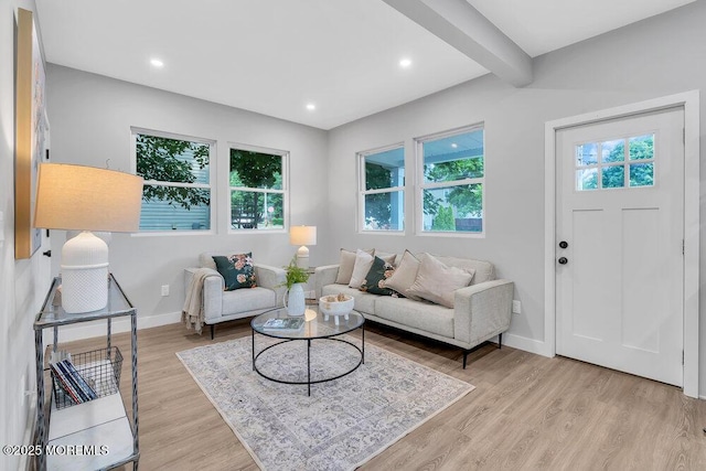 living room with light wood-type flooring and beam ceiling