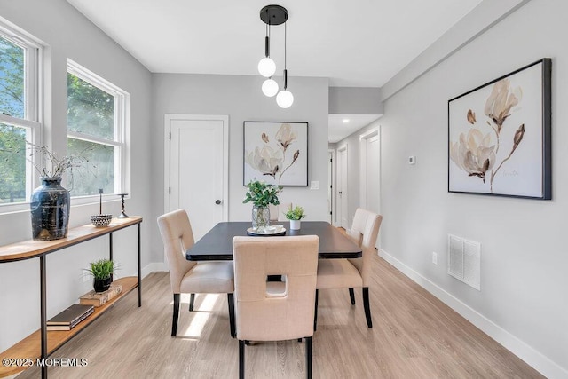 dining space featuring light wood-type flooring