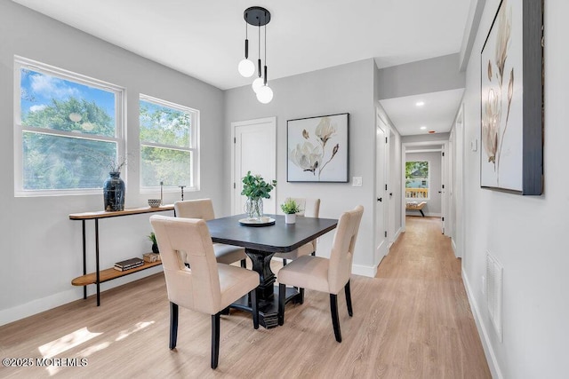 dining space with light hardwood / wood-style flooring