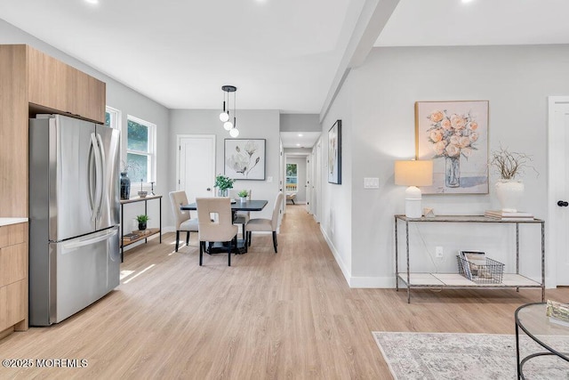 dining space with light wood-type flooring and a wealth of natural light