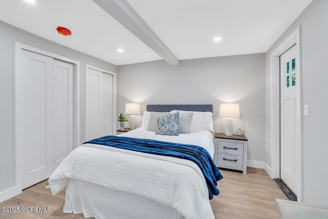 bedroom featuring beam ceiling and light hardwood / wood-style floors