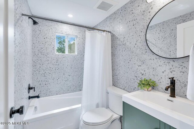 full bathroom with tile walls, toilet, shower / bath combo, and decorative backsplash