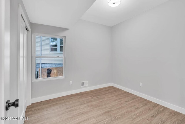 spare room featuring light wood-type flooring