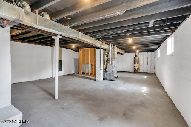 basement featuring water heater and heating unit