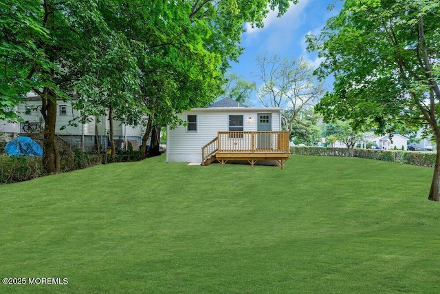 back of property featuring a yard and a wooden deck