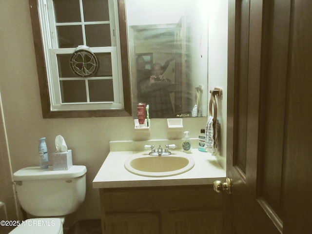 bathroom featuring toilet and vanity