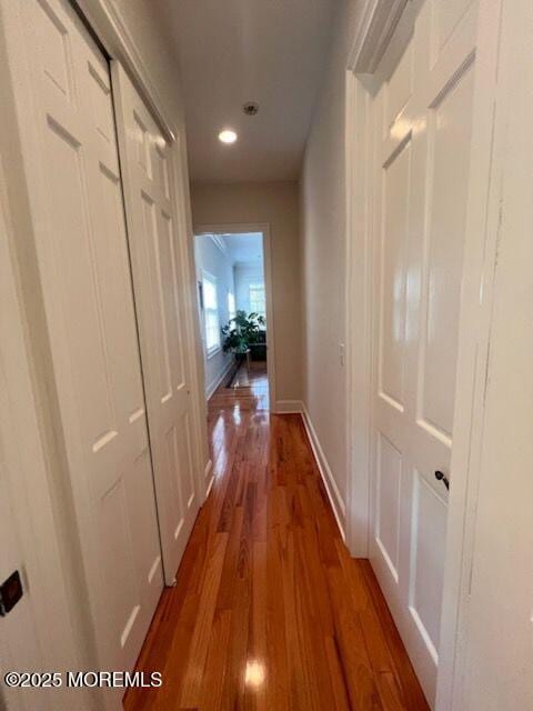 hallway with hardwood / wood-style floors