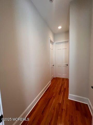 corridor with dark hardwood / wood-style floors