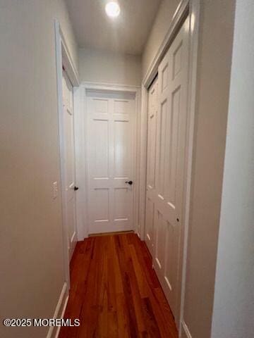 hall with dark wood-type flooring