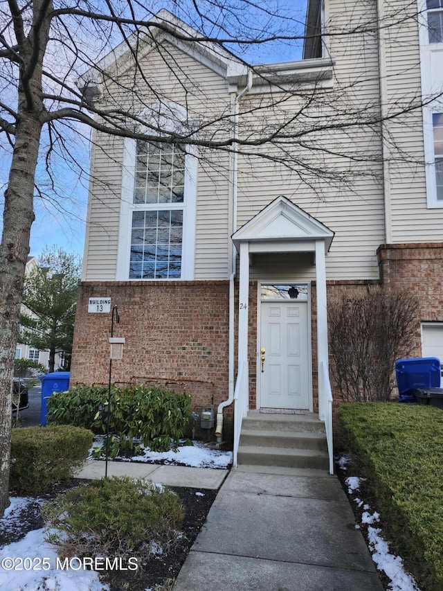 view of snow covered property entrance