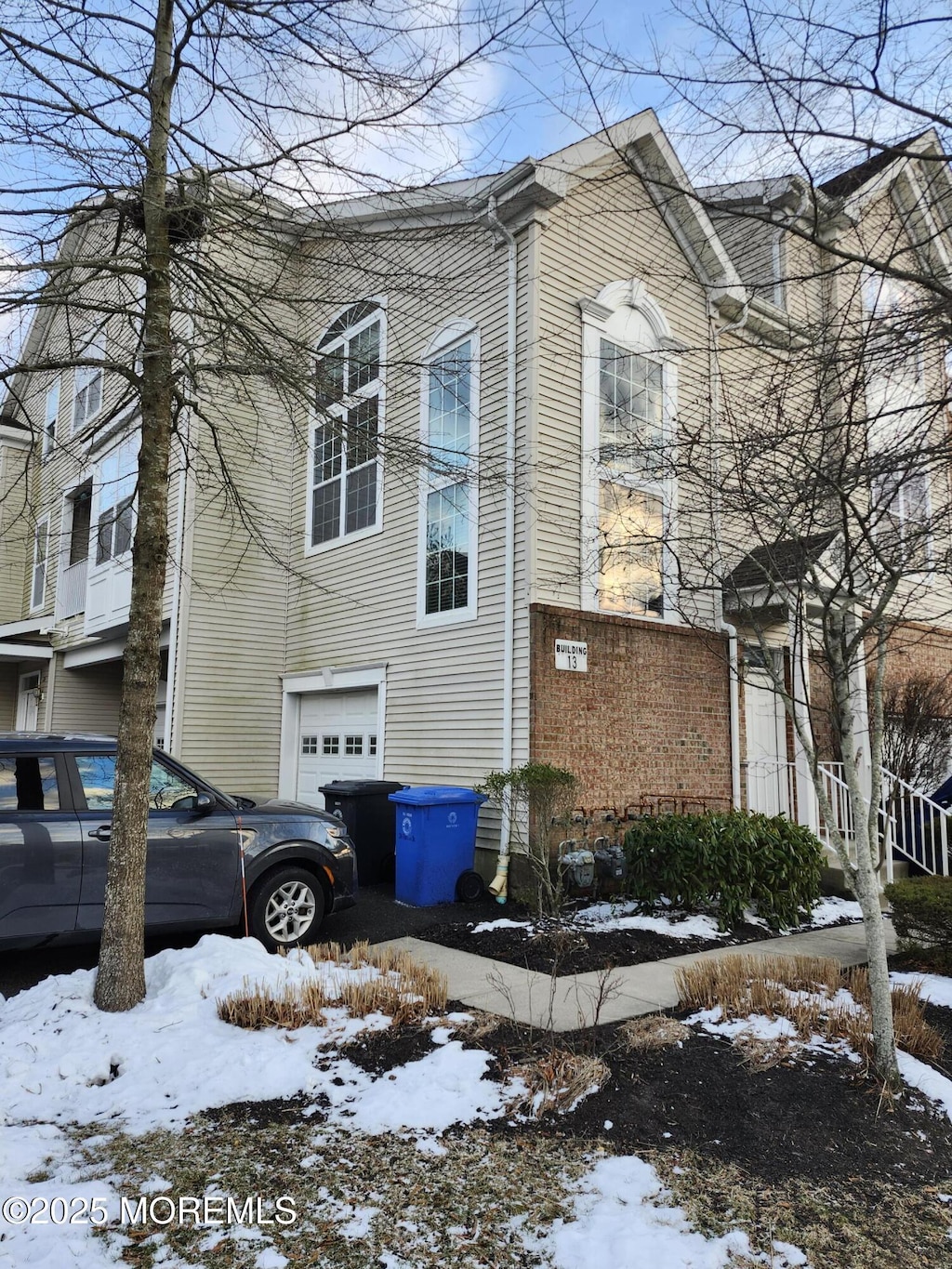 view of snowy exterior with a garage